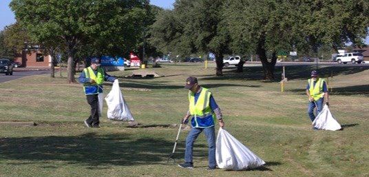 Three men working on the Great Granbury Cleanup
